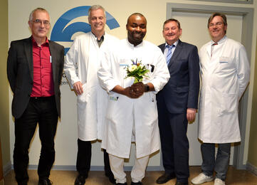 Kleine Feierstunde zur Ernennung mit (v.l.n.r.): Personalleiter Peter Boemans, Chefarzt Prof. Christof Klötzsch, Oberarzt Dr. Edward Ejiugwo, GLKN-Geschäftsführer Peter Fischer und der stellvertretende Ärztliche Direktor Prof. Andreas Trotter. Bild: aj