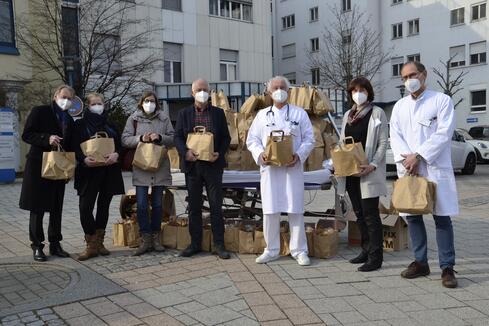 Ein Klinikbett voller Care-Pakete für die Corona-Kümmerer des Radolfzeller Krankenhauses: Die Vertreter des Krankenhaus Fördervereins Johannes Kögel (Vorsitzender) und Dr. Susanne Bock übergaben gemeinsam mit Mitgliedern des Rotary Clubs Radolfzell-Hegau Cornelia Bambini-Adam und Dr. Jürgen Mäder (Präsident) die Care-Pakete an den Chefarzt für Innere Medizin Dr. Sebastian Jung, Pflegedienstleiterin Marlies Hafner und den Chefarzt des Zentrums für Altersmedizin Dr. Achim Gowin. Bild: Jagode 